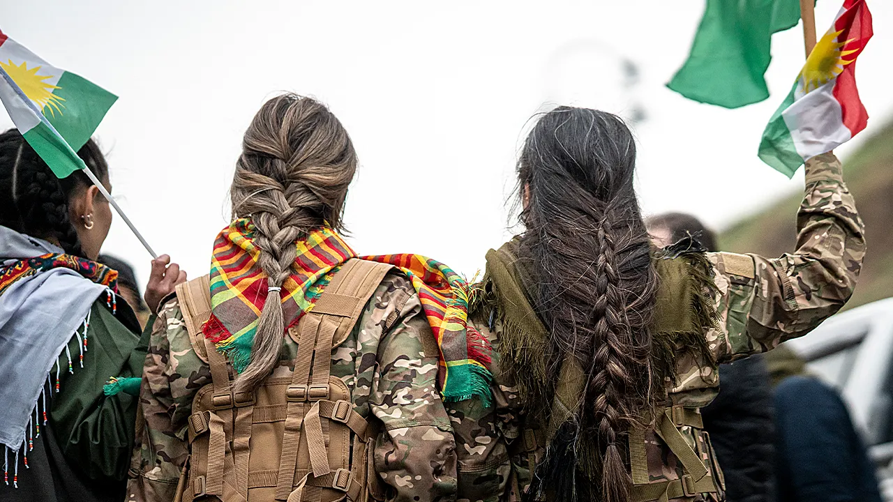 Video shows Syrian fighter with braid he says is from a Kurdish woman in Raqqa.