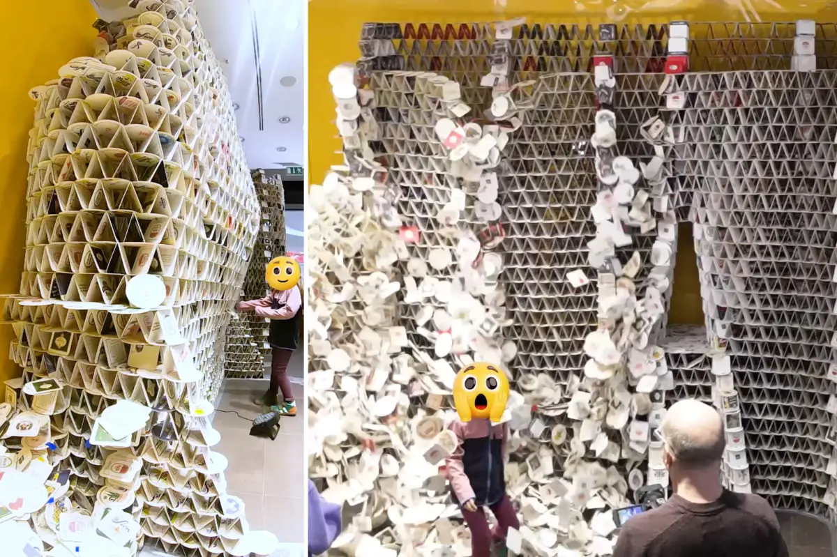 Young girl knocks down tower made from 63,000 beer coasters built by artist to set a Guinness World Record