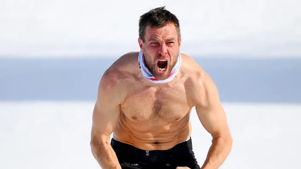 Benjamin Karl celebrates his snowboard gold medal at the Olympics by shedding his clothes.