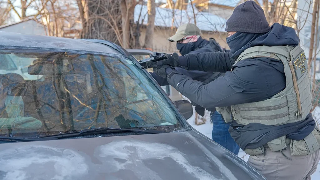 Images capture armed ICE agents facing off against Minneapolis protesters.