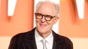 John Lithgow supports his role in 'Harry Potter' even with Rowling's 'ironic' views on transgender issues.