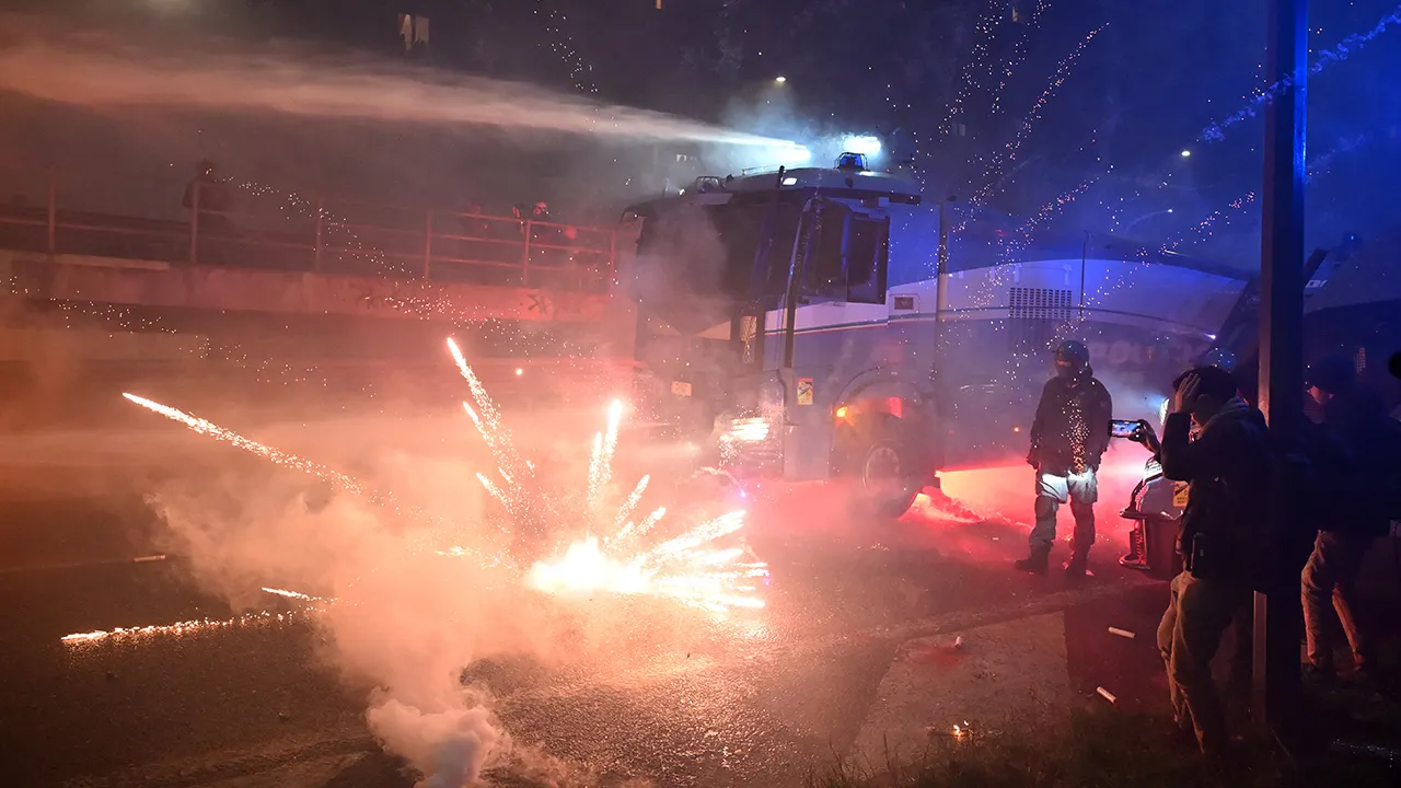 Protesters confront police near the Winter Olympics site in Milan