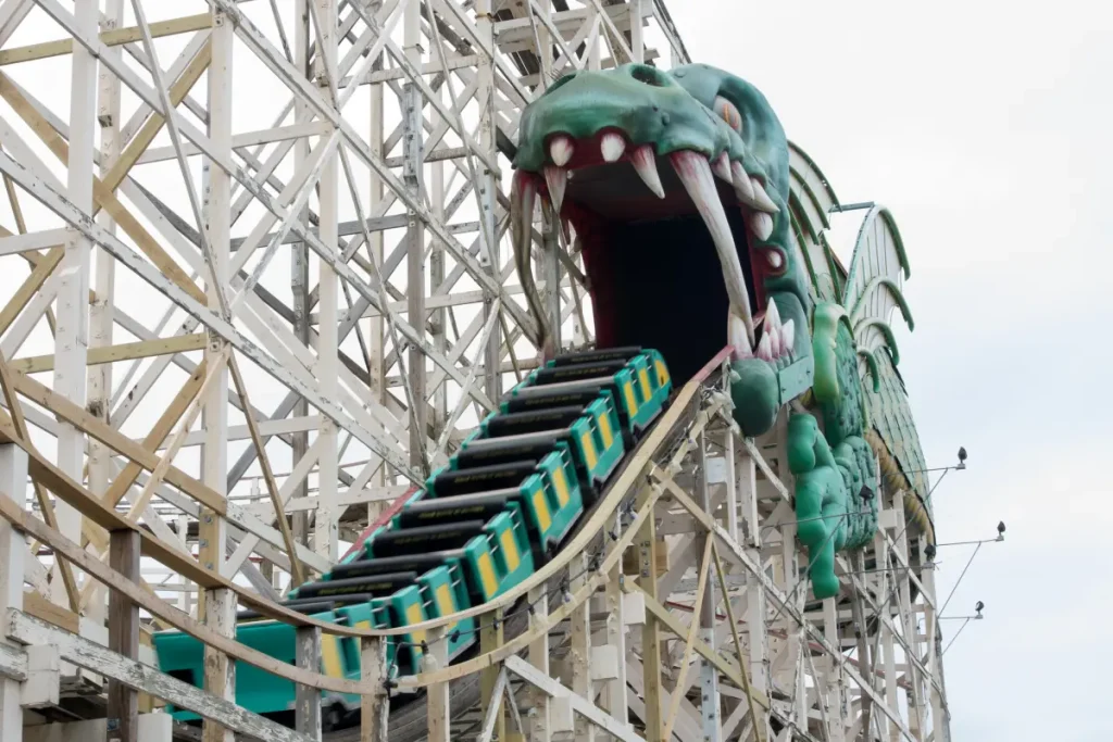 Residents react strongly as dragon from famous amusement park ride is thrown in the trash.