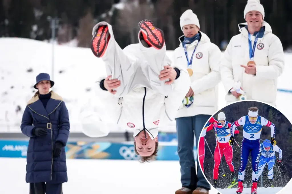 Skier Ben Ogden performs a backflip on the podium following his silver medal achievement