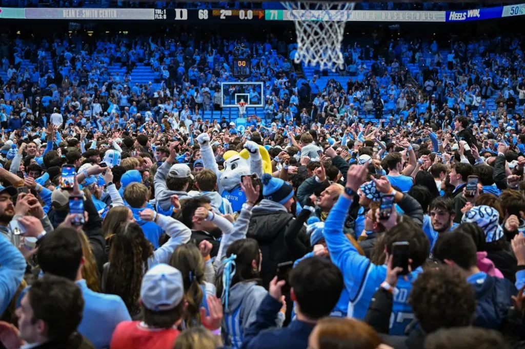 UNC supporters rush the court early against rival Duke in chaotic scene