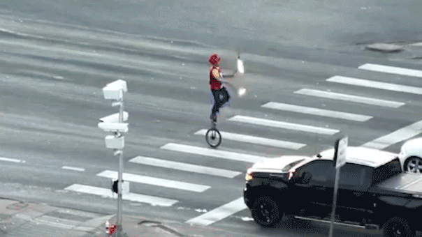 Unicyclist juggling fire disrupts traffic at a busy Colorado intersection