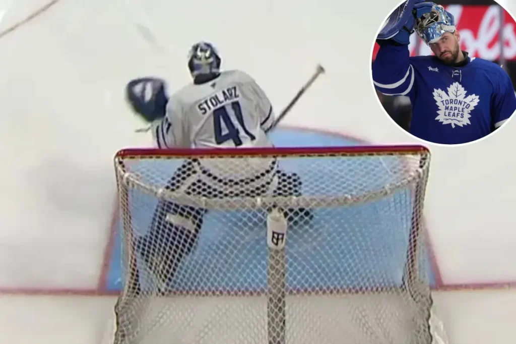 Anthony Stolarz of the Maple Leafs gets hit in the throat by a puck during warmups