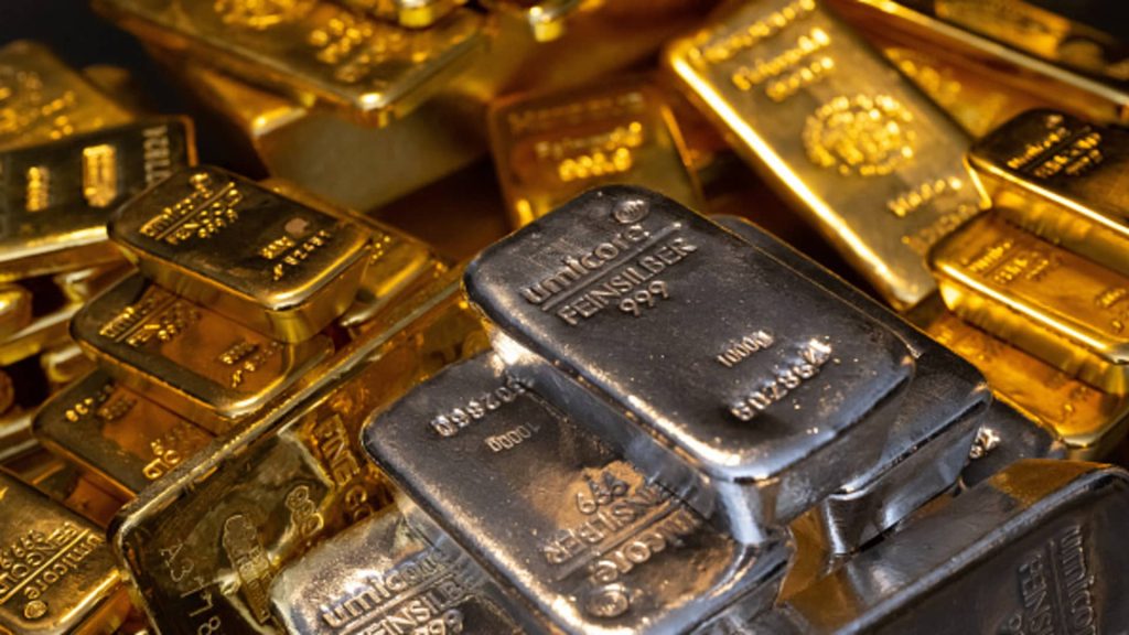 Gold rises, while silver continues to decline as fluctuating oil prices create market instability.