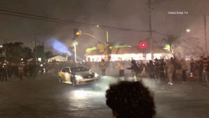 LA street takeover ensnares Metro bus, passengers observe as crowd damages it