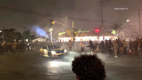 LA street takeover ensnares Metro bus, passengers observe as crowd damages it