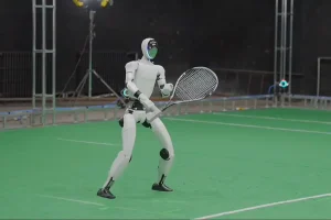 Robot that looks like a human is shown playing tennis with people in a video