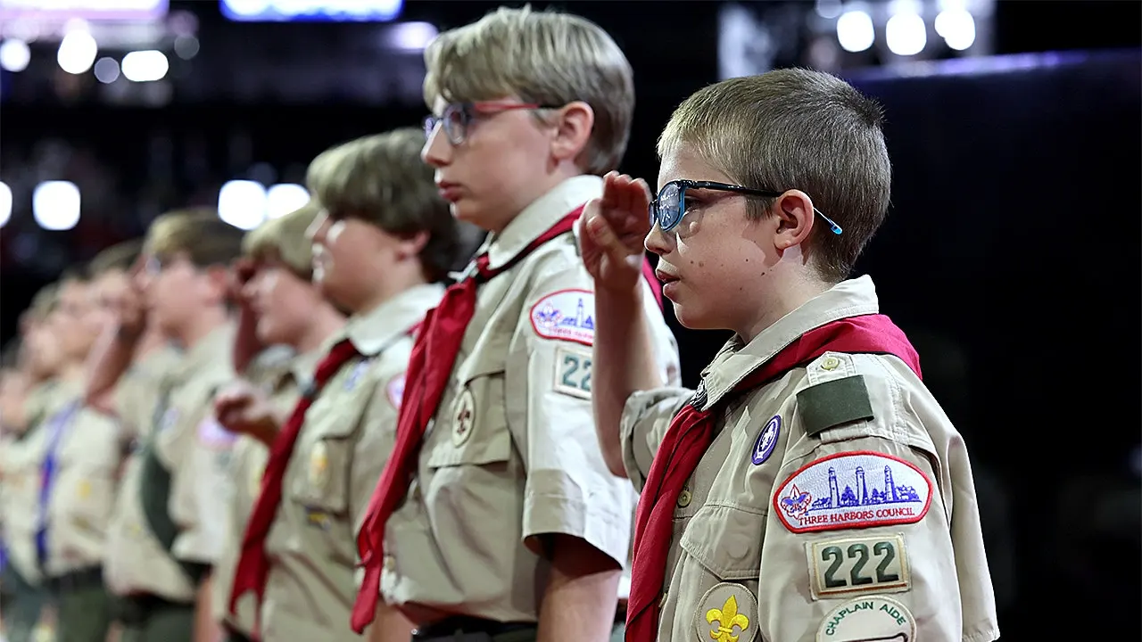 Scouting America aims to move away from 'woke' branding by emphasizing military aspects.