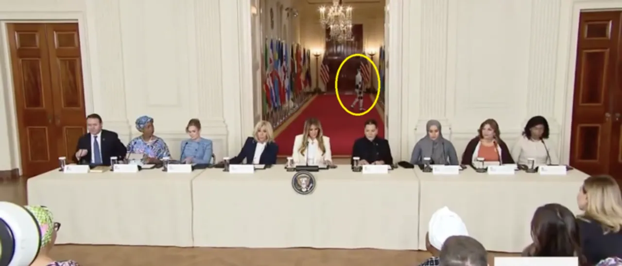 See the strange moment as a robot that moves like Joe Biden vanishes behind Melania.
