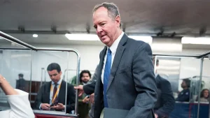 Tricia McLaughlin's husband seeks an apology from Democrats regarding contract claims.