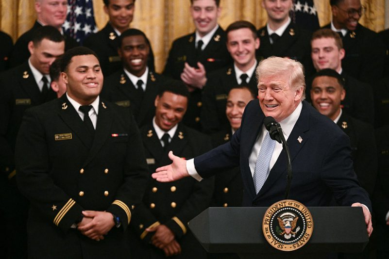 Trump pays tribute to the Navy football team at the White House and signs an order to protect the broadcast schedule of the Army-Navy game.
