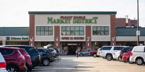 Video: Woman in the nude with a dog in a stroller bites a shopper and assaults others at a grocery store, according to police.