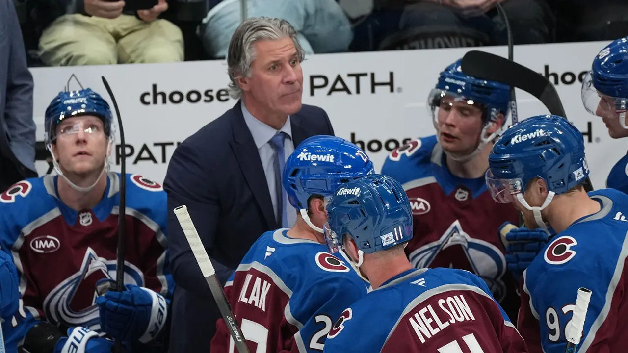 Avalanche coach Jared Bednar leaves after being hit in the face with a puck, resulting in fractures.