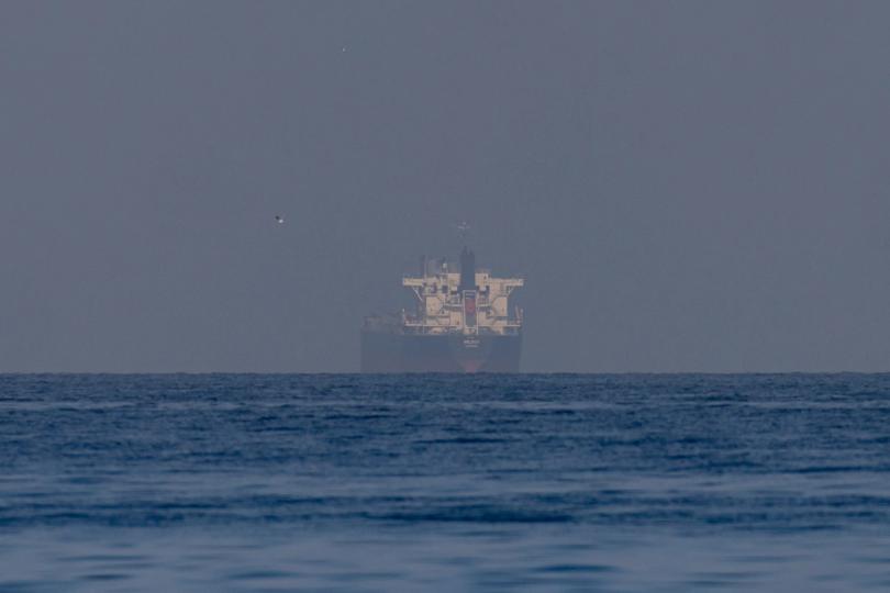 Bitcoin drops $77,000, while ether and solana decline as Hormuz tensions push oil prices to a three-week high.