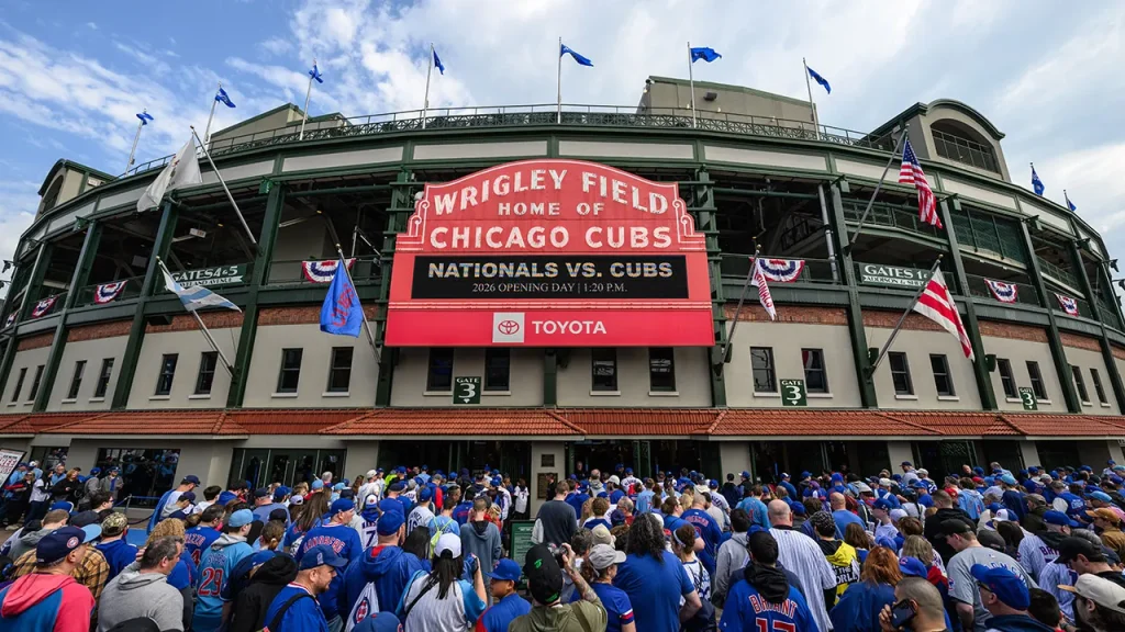 Cubs supporter seen using laptop at chilly Wrigley Field game