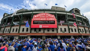 Cubs supporter seen using laptop at chilly Wrigley Field game