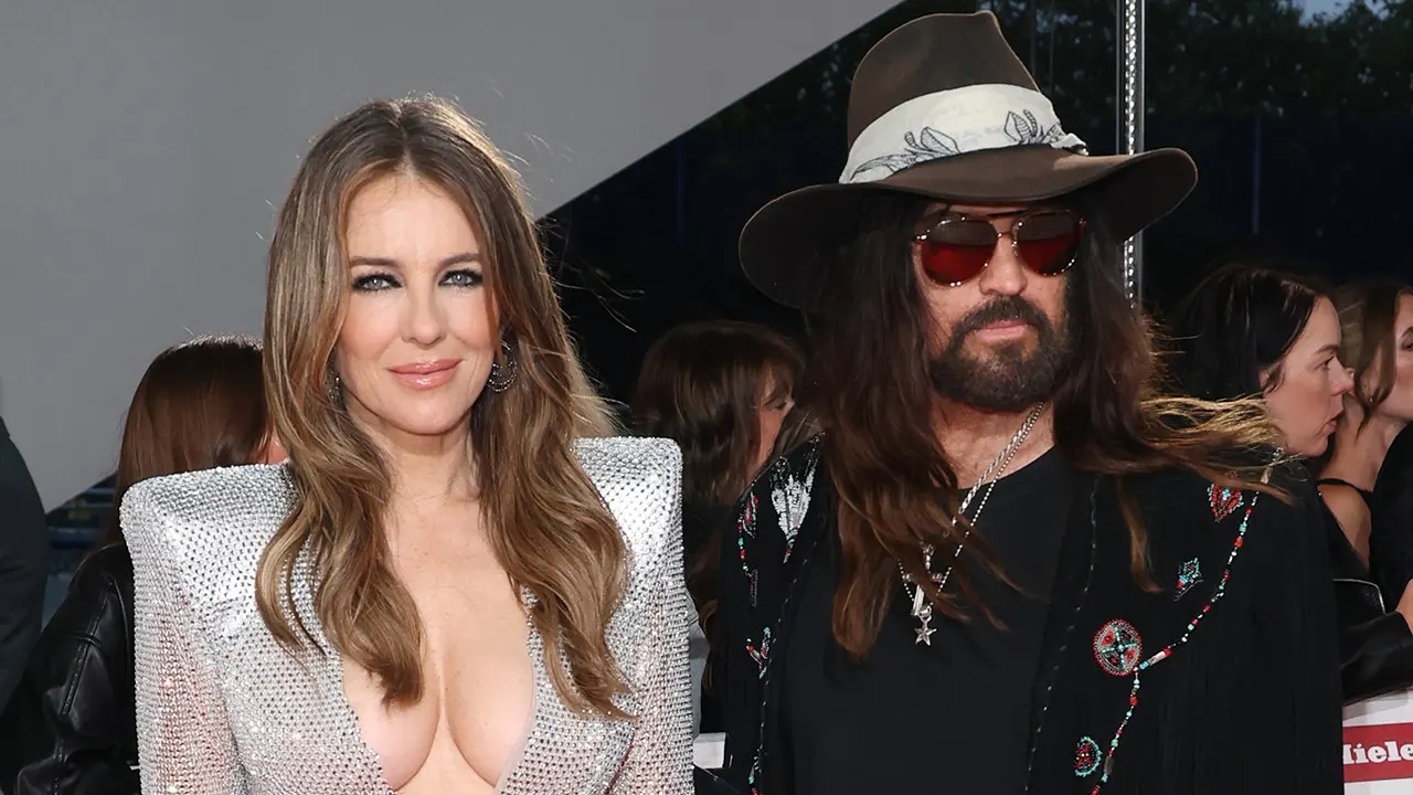 Elizabeth Hurley and Billy Ray Cyrus attend the Olivier Awards red carpet event