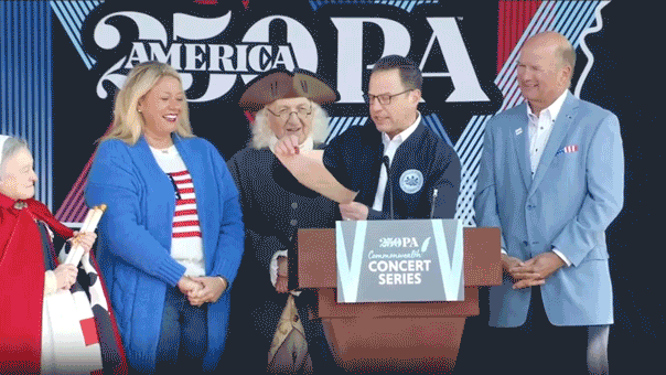 Governor Shapiro came close to being struck by a collapsing backdrop during the America250 event.