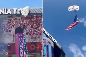 Parachutist crashes into Virginia Tech scoreboard, shocking the audience and causing a delay in the football game.