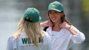 Paulina Gretzky serves as a caddy for Dustin Johnson during the Masters Par 3 Contest