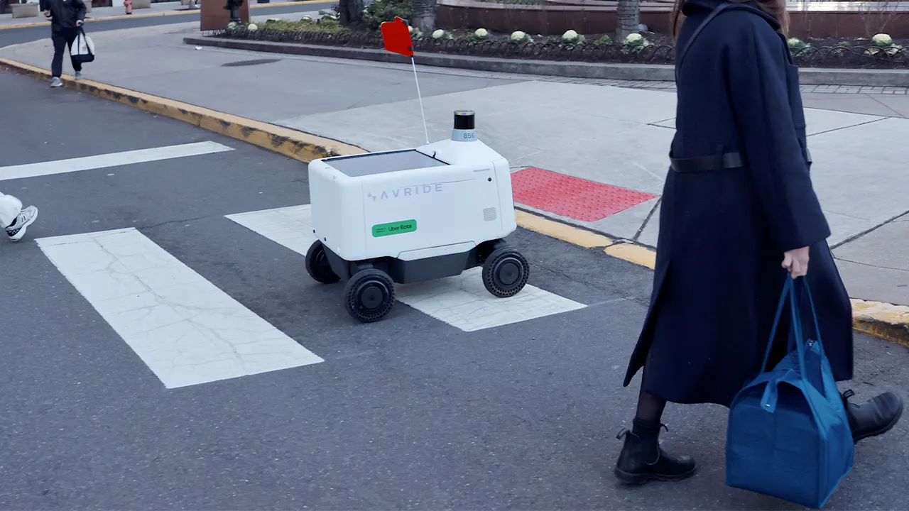 Philadelphians kick and sit on Uber Eats delivery robots
