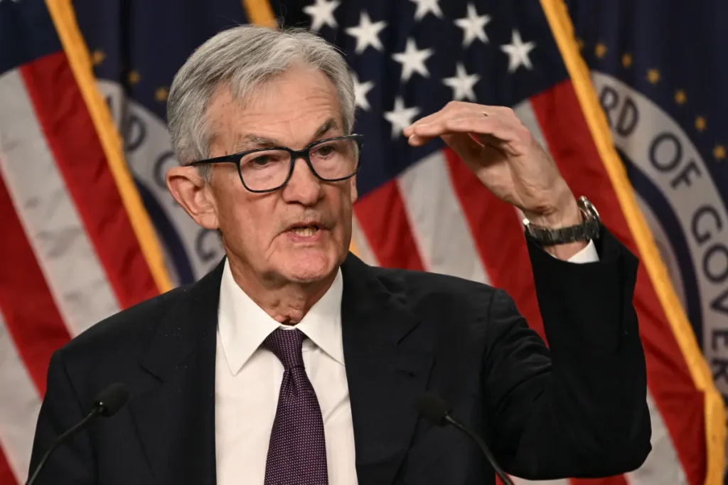 Powell announces he will remain as governor following the Fed's decision to maintain interest rates.