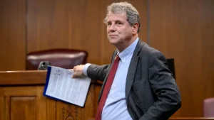Sherrod Brown receives criticism for supporting a judge who likened voter ID to racial oppression.