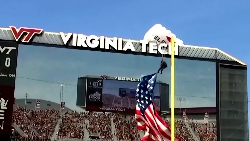Skydiver claims that jumbotron collision at Virginia Tech spring event saved him.