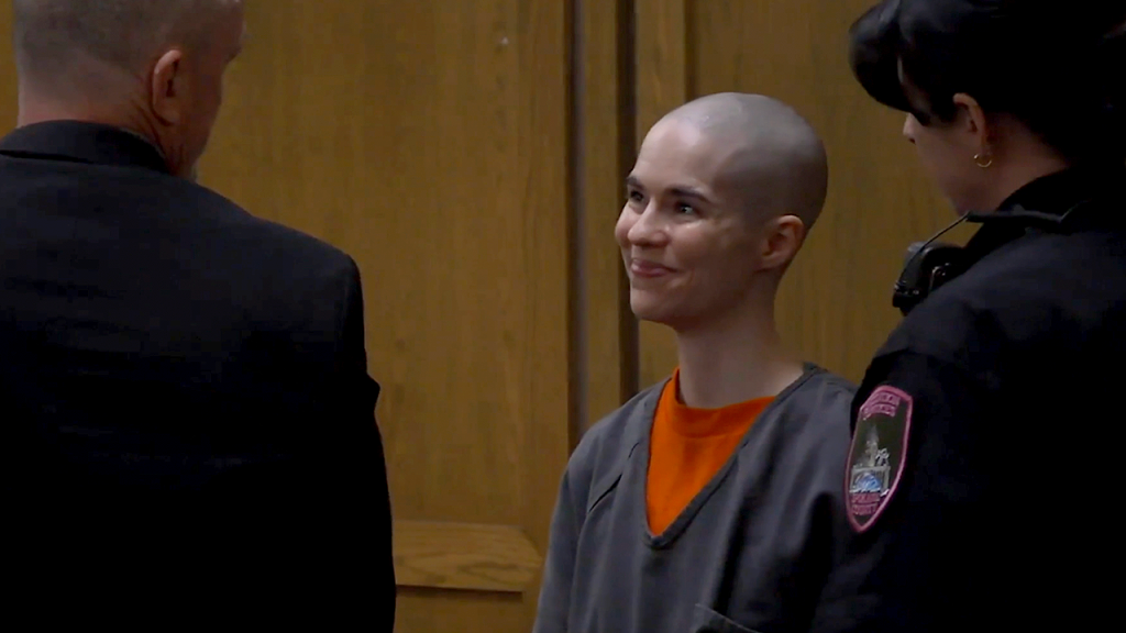 Woman who smiled in court receives 28 years for killing her father