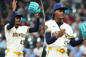 Abner Uribe of the Brewers performs a lively 'suck it' gesture at the Cardinals