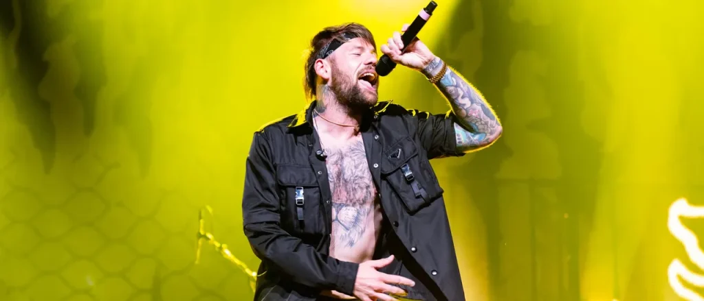 Beartooth's Caleb Shomo Reveals He's Gay After 14 Years Of Marriage. Wife Reacts.