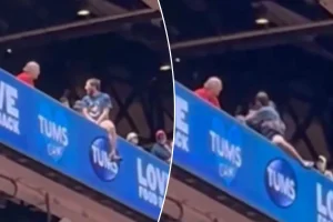 Cardinals supporter precariously dangles from upper deck ledge in alarming situation