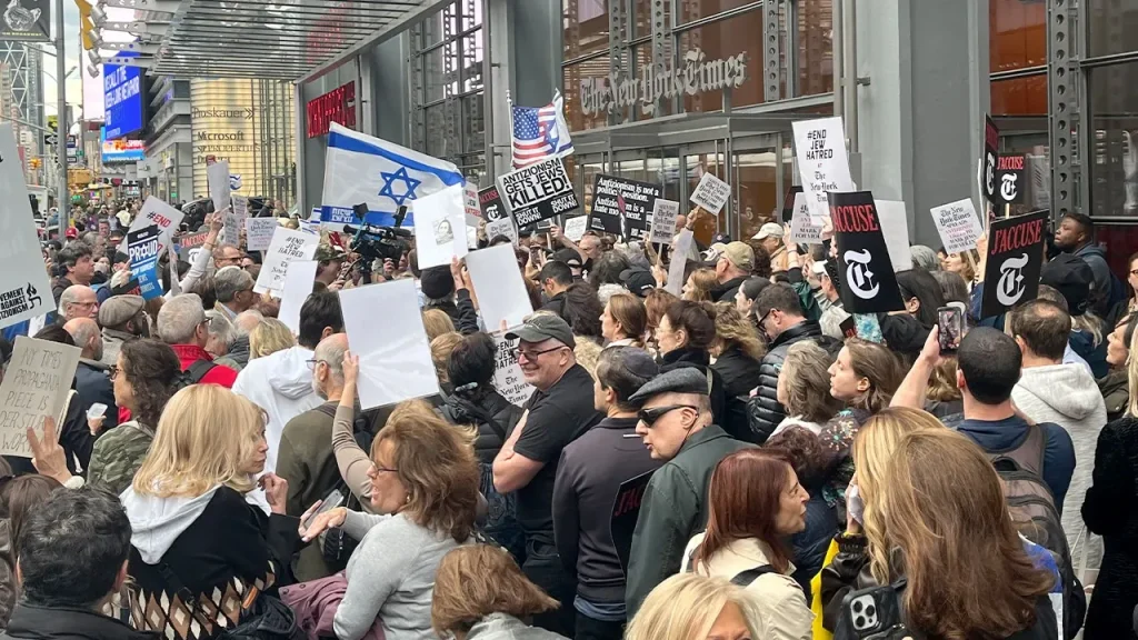 Demonstrators gather outside the New York Times, calling for Kristof's dismissal over article