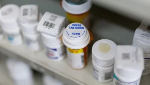 Doctor and son face charges for operating a prescription drug operation.