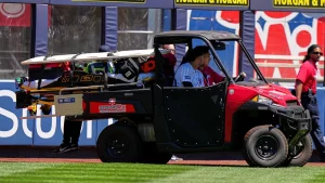 Jasson Dominguez of the Yankees taken off the field after colliding with the wall while making a catch