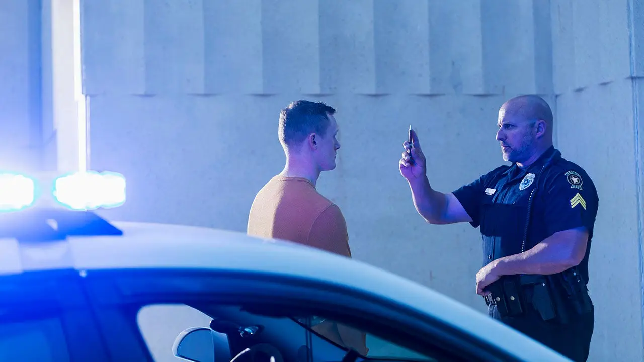 Man engages in a game of musical chairs with his friend after arriving intoxicated to retrieve them from a DWI arrest.