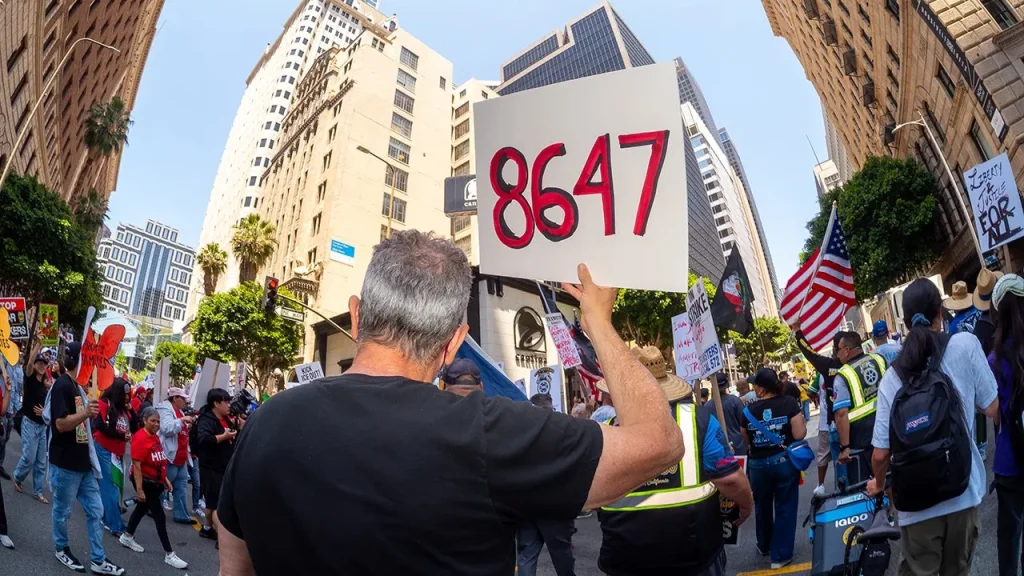 May Day demonstration: '86 47' signs appear after Comey's indictment