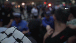 Protesters against Israel confront police outside a synagogue in Manhattan.