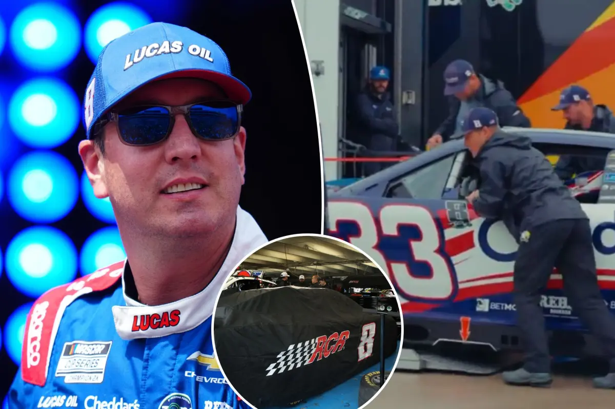 The NASCAR garage observes quietly as Kyle Busch's car is taken off the truck at the track.