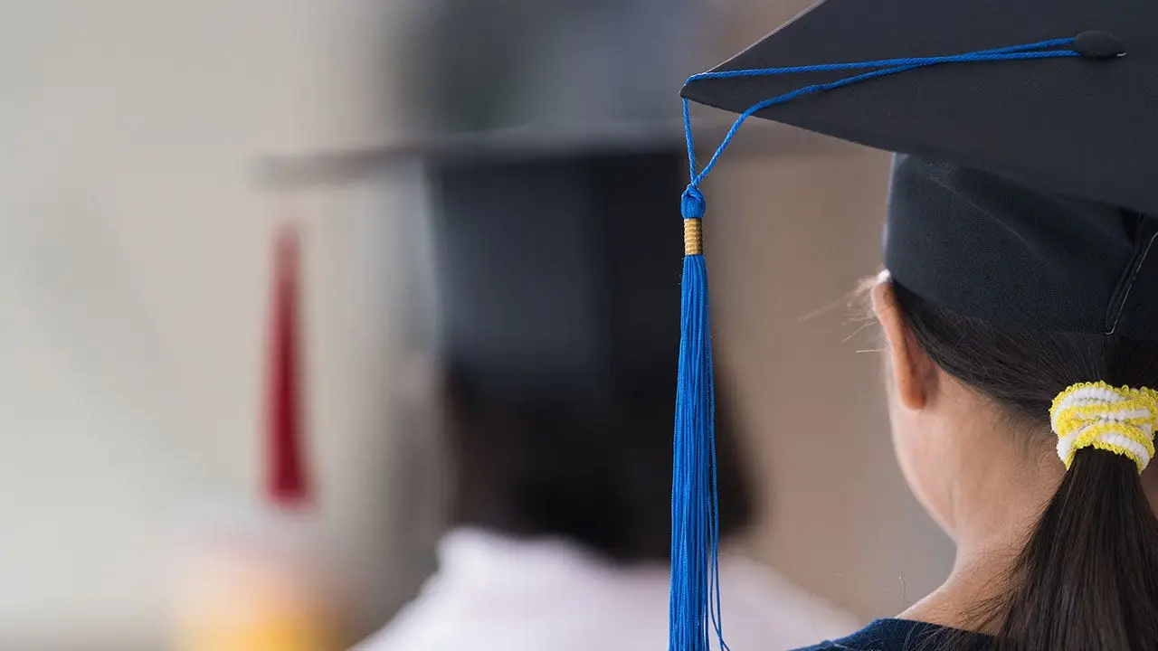 Woman involved in viral kindergarten graduation fight is puzzled about why her face was seen everywhere.