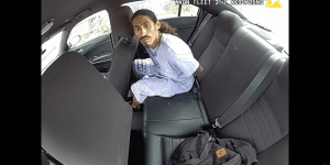 Alarming video shows a suspect escaping from a police car after taking off his handcuffs and getting into the driver's seat while an officer attempts to intervene.