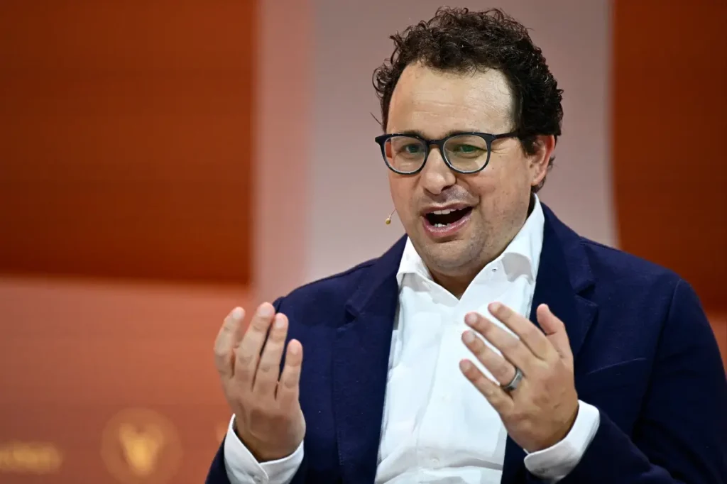 Anthropic urges a worldwide pause on AI development following a $965B valuation, while critics argue it's meant to weaken rivals.