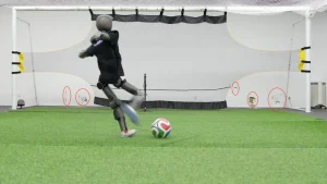 Booster Robotics T1 robot hits soccer balls with enough force to leave dents in walls