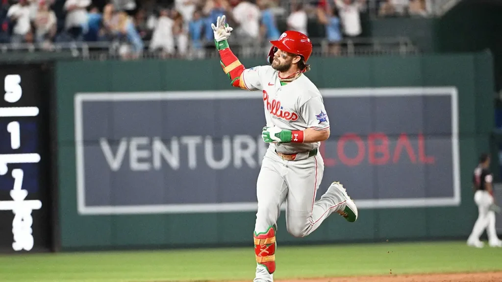 Bryce Harper answers rude chants from Nationals fans with a home run and a gesture while rounding the bases.