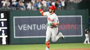 Bryce Harper answers rude chants from Nationals fans with a home run and a gesture while rounding the bases.