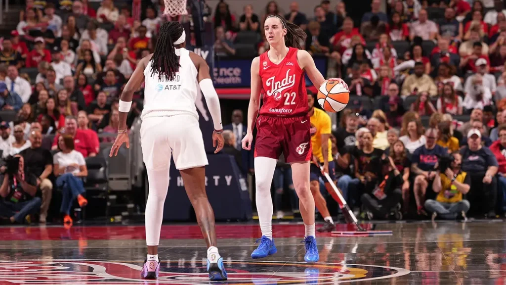 Caitlin Clark showcases her exclusive Nike shoe while walking through the Fever tunnel.